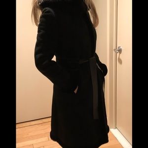 Searle black shearling knee length coat.